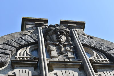 Low angle view of statue against clear blue sky