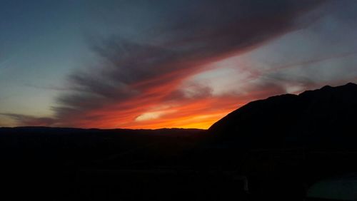 Scenic view of silhouette mountains against sky during sunset