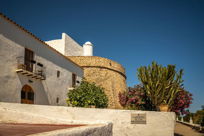 Low angle view of building against clear blue sky