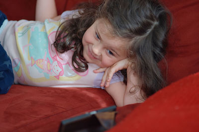 Pretty girl talking to grandma on the phone via video chat