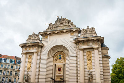 Low angle view of historical building against cloudy sky