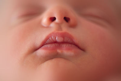 Close up detail of newborn baby mouth lips and nose