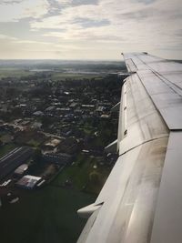 Aerial view of airplane wing against sky