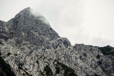 Low angle view of rock formation against sky