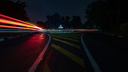 Light trails on road in city at night