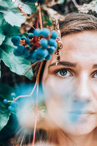 Close-up portrait of woman by plant