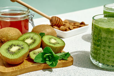 Green smoothie with kiwi fruit in the glasses. healthy organic drink. nutrition and alkaline diet. 