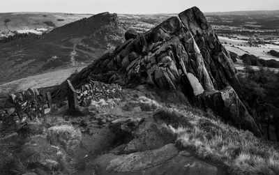 View of rocks on landscape against the sky