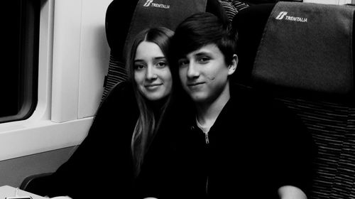 Portrait of young couple sitting in car