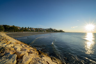 Scenic view of sea against clear sky during sunset