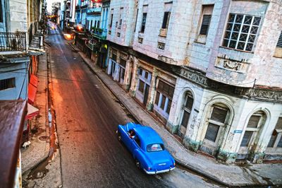 Cars on street amidst buildings in city