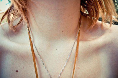 Midsection of woman wearing necklace