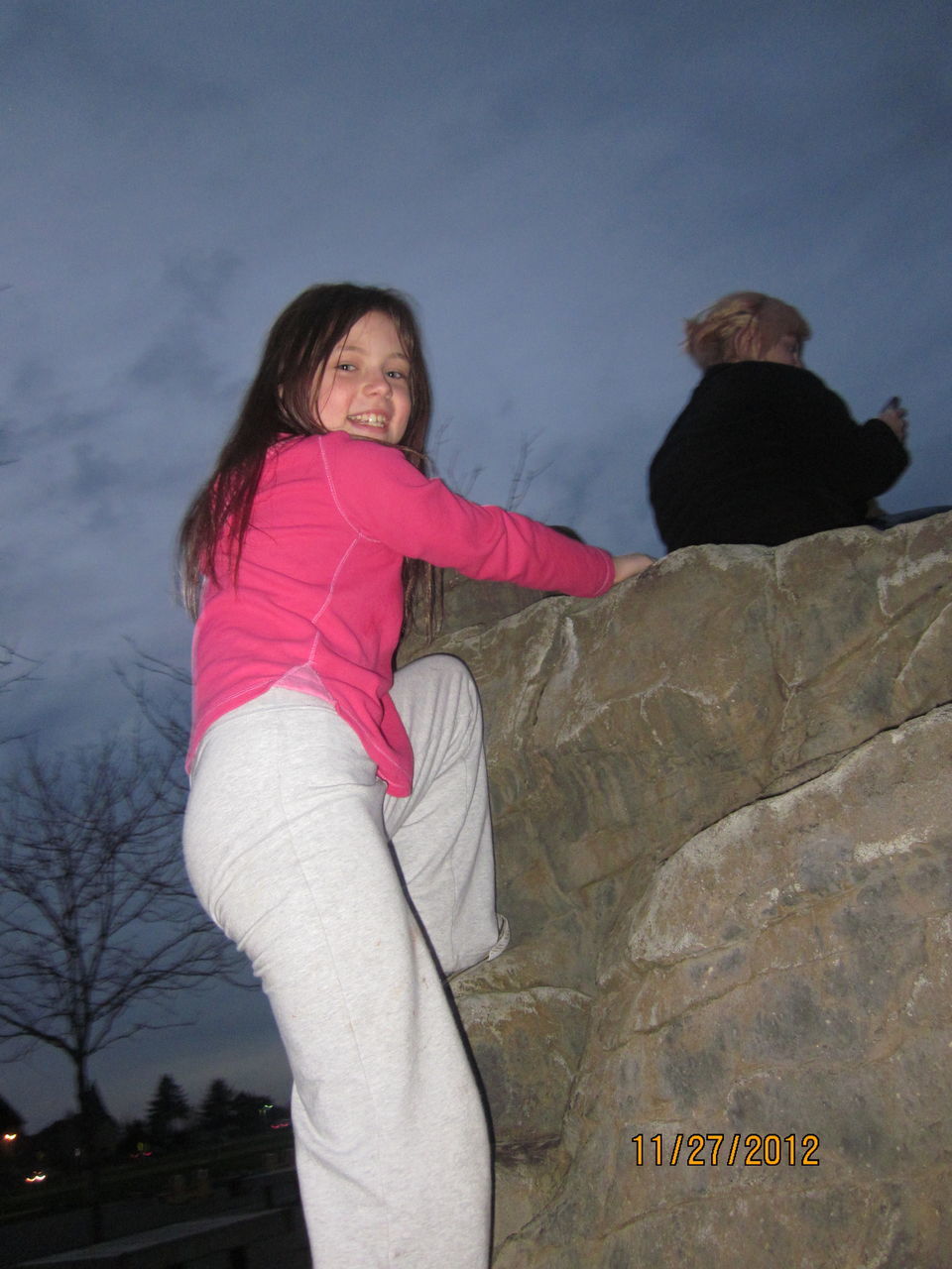 CLOSE-UP OF WOMAN STANDING ON WALL