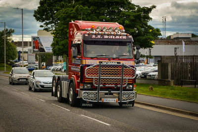 Vehicles on road against buildings in city