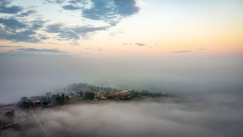 Aerial view of city against sky during sunset