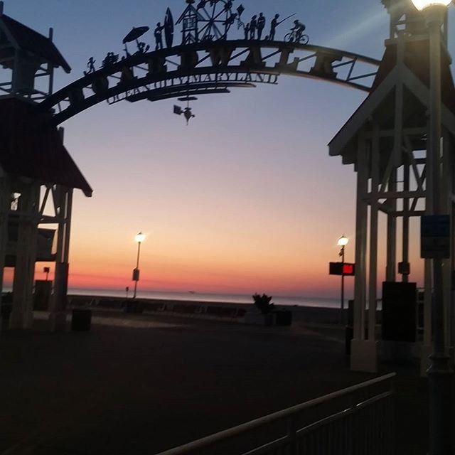 sunset, sea, silhouette, built structure, orange color, sky, beach, horizon over water, water, architecture, clear sky, scenics, incidental people, nature, sunlight, sun, beauty in nature, tranquility, railing, tranquil scene