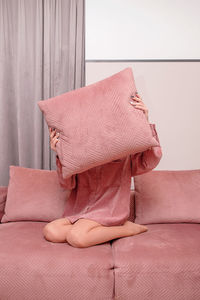 Close-up of pink girl dressed as couch