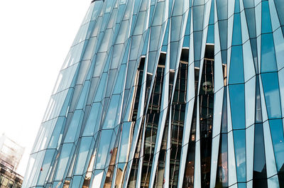 Low angle view of modern building against clear blue sky