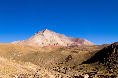 Scenic view of mountains against clear blue sky