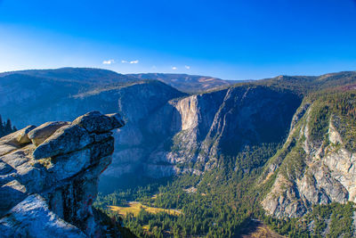 Scenic view of mountains against blue sky