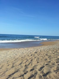 Scenic view of beach against clear sky