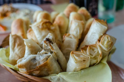 Close-up of spring rolls in container