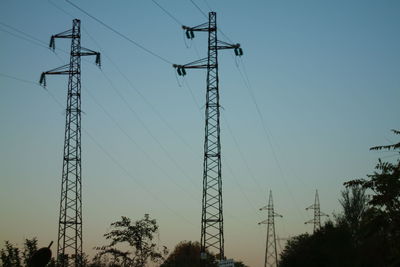 Low angle view of electricity pylon against sky