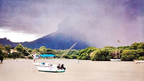 Scenic view of mountains against cloudy sky