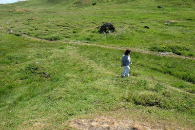 Rear view of man walking on field