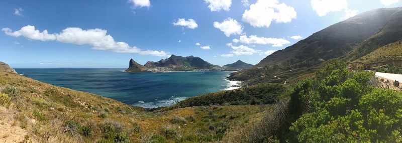 Panoramic view of sea and mountains against sky