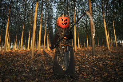 Rear view of woman standing on field