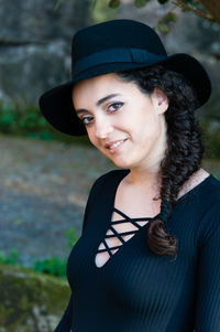 Portrait of smiling young woman standing outdoors