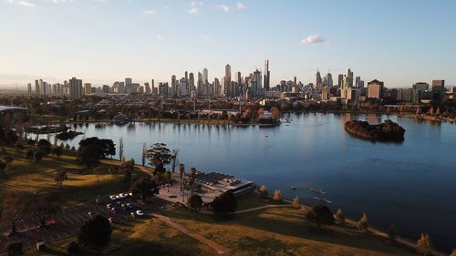 High angle view of buildings by river against sky