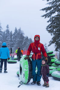 A portrait of a father and his daughter at the tubing hill in oregon.