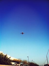 Low angle view of airplane flying in sky