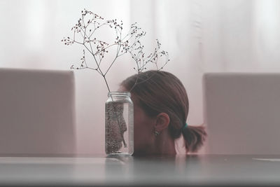 Woman by glass container