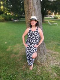 Portrait of smiling girl on tree trunk