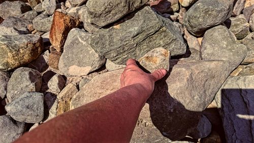 Cropped image of hand holding rock