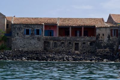 House by sea against sky