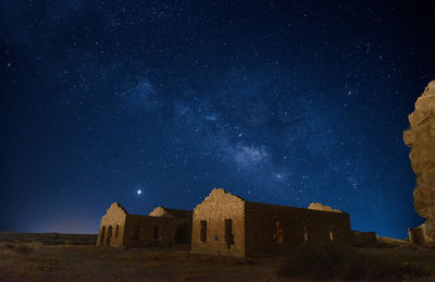 Low angle view of old building against sky at night