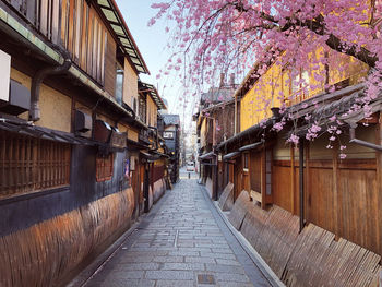 Empty street amidst buildings in city