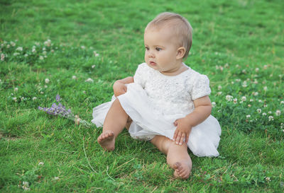 Portrait of cute boy standing on grass