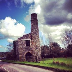 Low angle view of castle against cloudy sky