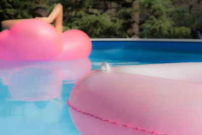 Pink inflatable ring floating at swimming pool