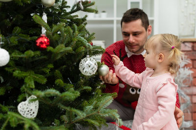 Portrait of boy playing with christmas tree