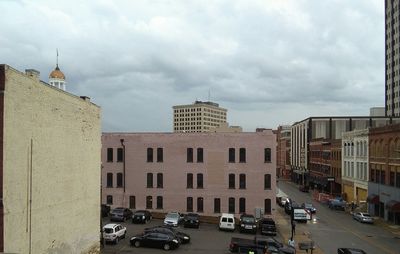 View of buildings in city against cloudy sky