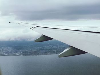 Aerial view of airplane wing against sky