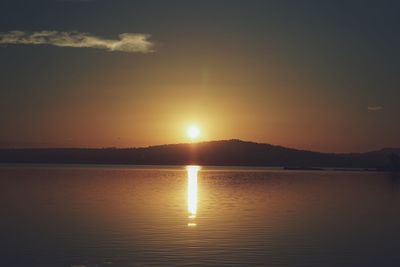 Scenic view of lake against sky during sunset