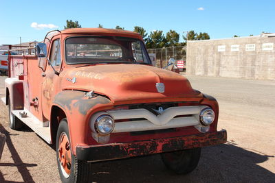 Vintage car on road in city against sky