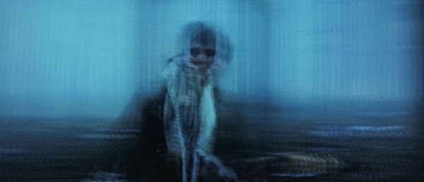 Blurred motion of woman in rain